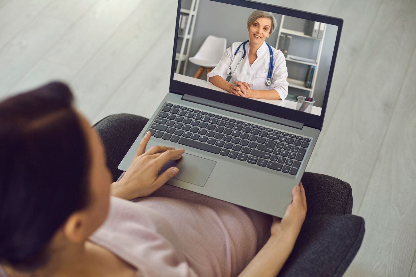 Smiling Doctor Therapist Consulting Man Patient Online from Laptop