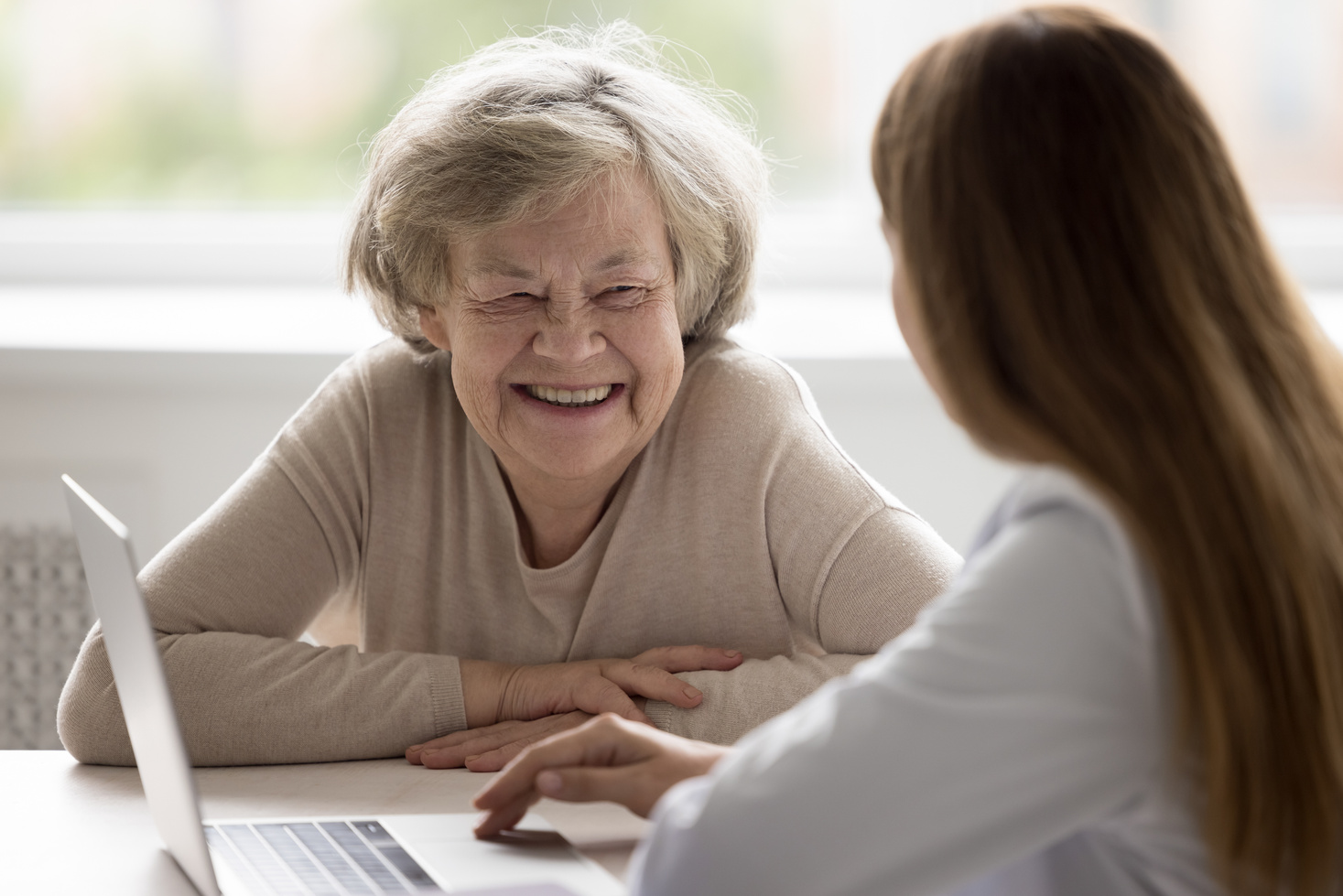 Happy positive older patient visiting geriatrician, consulting doctor